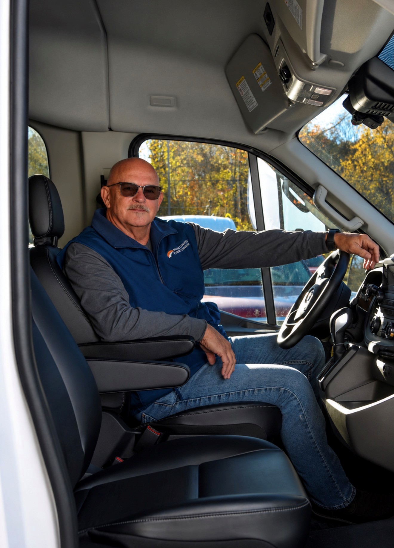 A Meigs County Public Transit driver beside an MCPT van