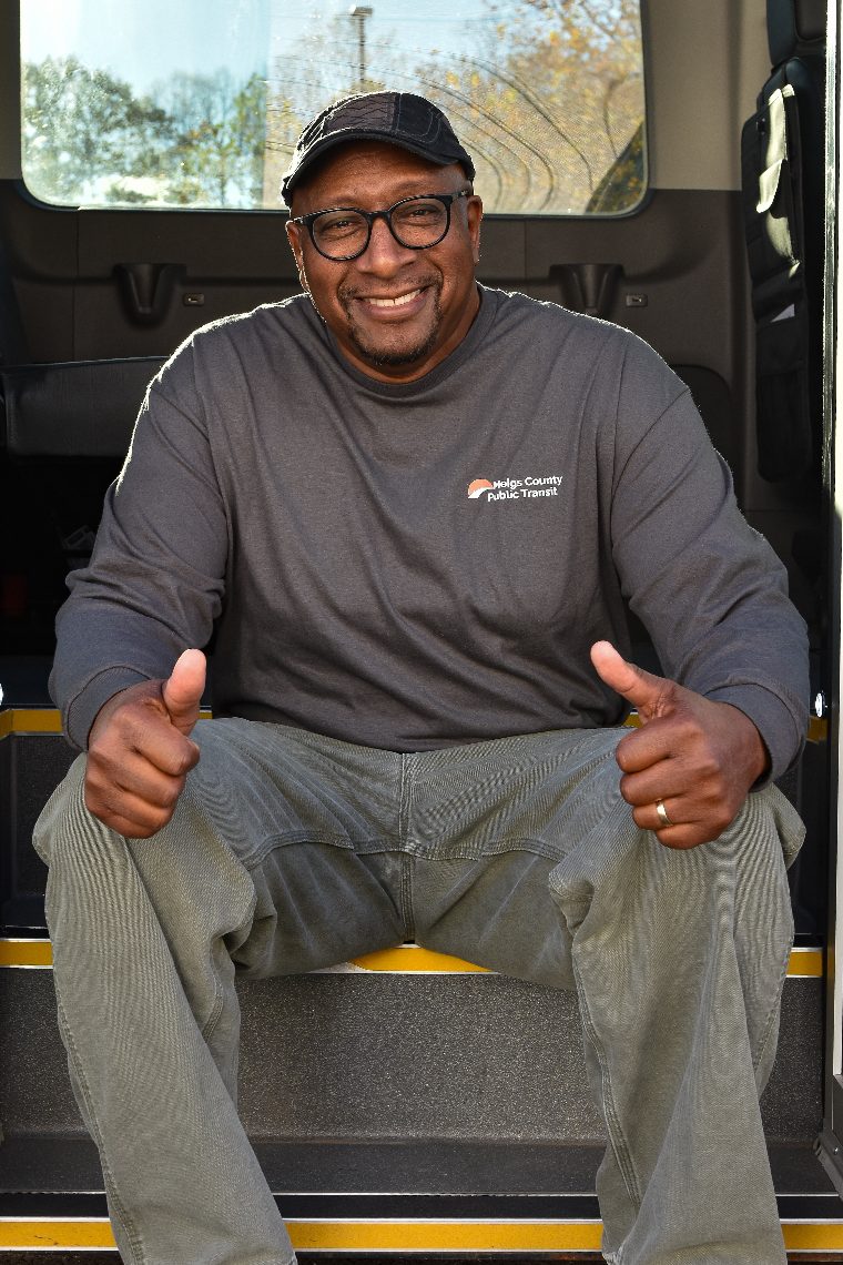 An MCPT driver giving a thumbs up from the door of a transit van