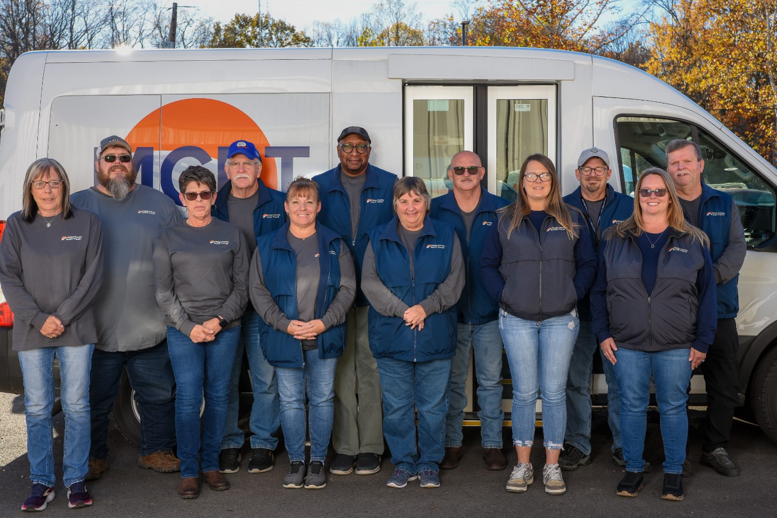 The Meigs County Public Transit team standing in front of an MCPT van